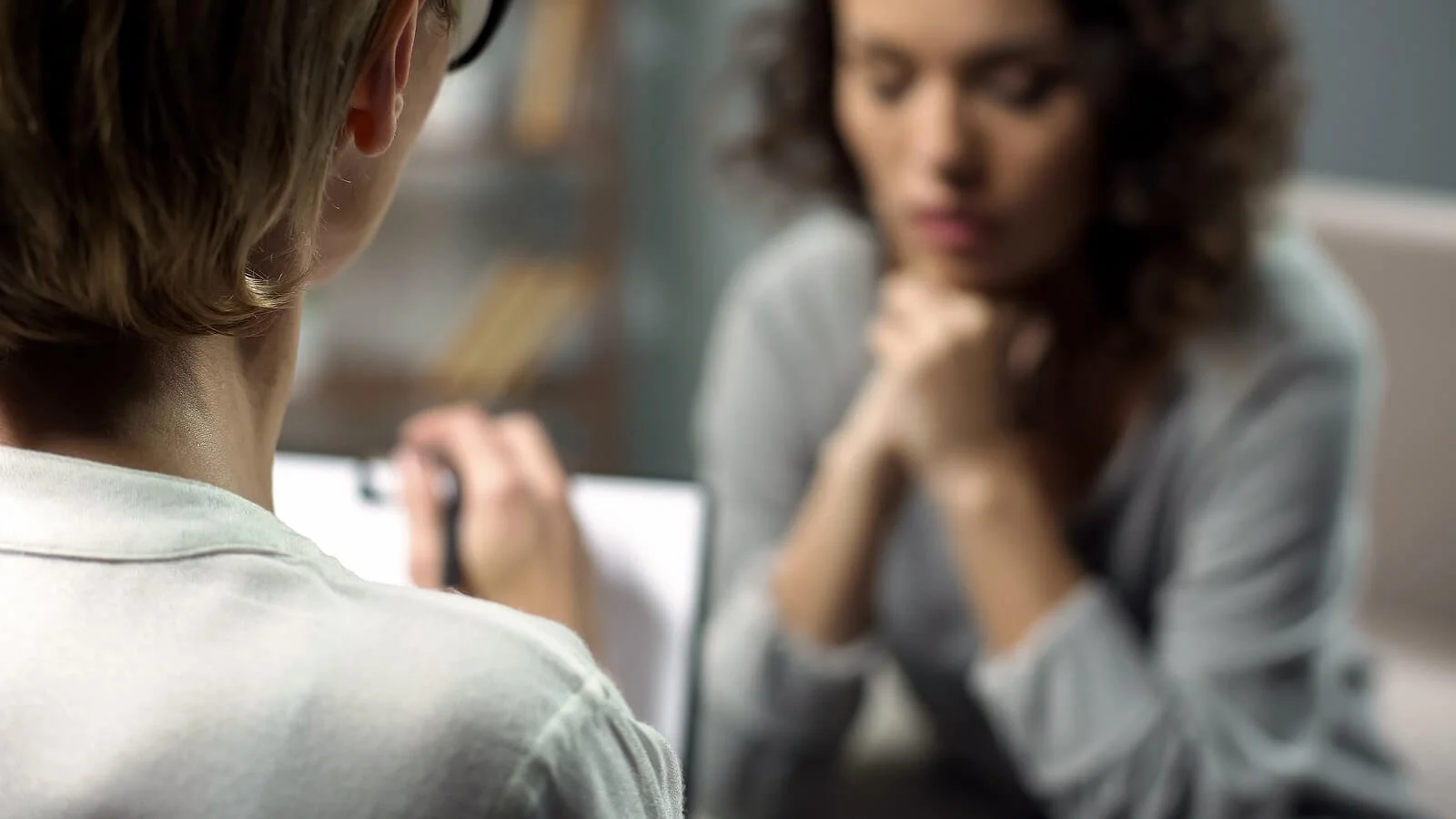 A close-up of a therapist taking notes on their clipboard as a patient sits across from them. This could represent the support an anxiety therapist in Broomfield, CO can offer via anxiety treatment in Broomfield, CO. Learn more about anxiety treatment in Denver, CO by searching anxiety therapist near me.  