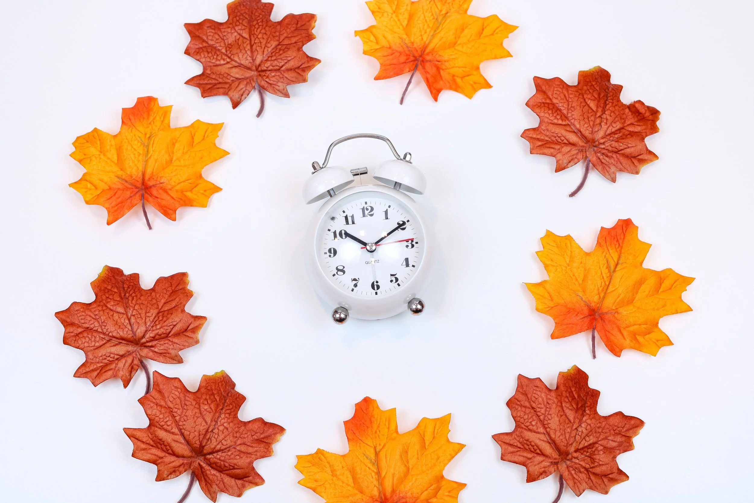  Orange leaves surrounding an alarm clock. Representing the 4 tips about surviving daylight savings from a depression therapist in Broomfield, CO. You can start treatment for SAD with depression therapy in Denver or Broomfield, CO. 