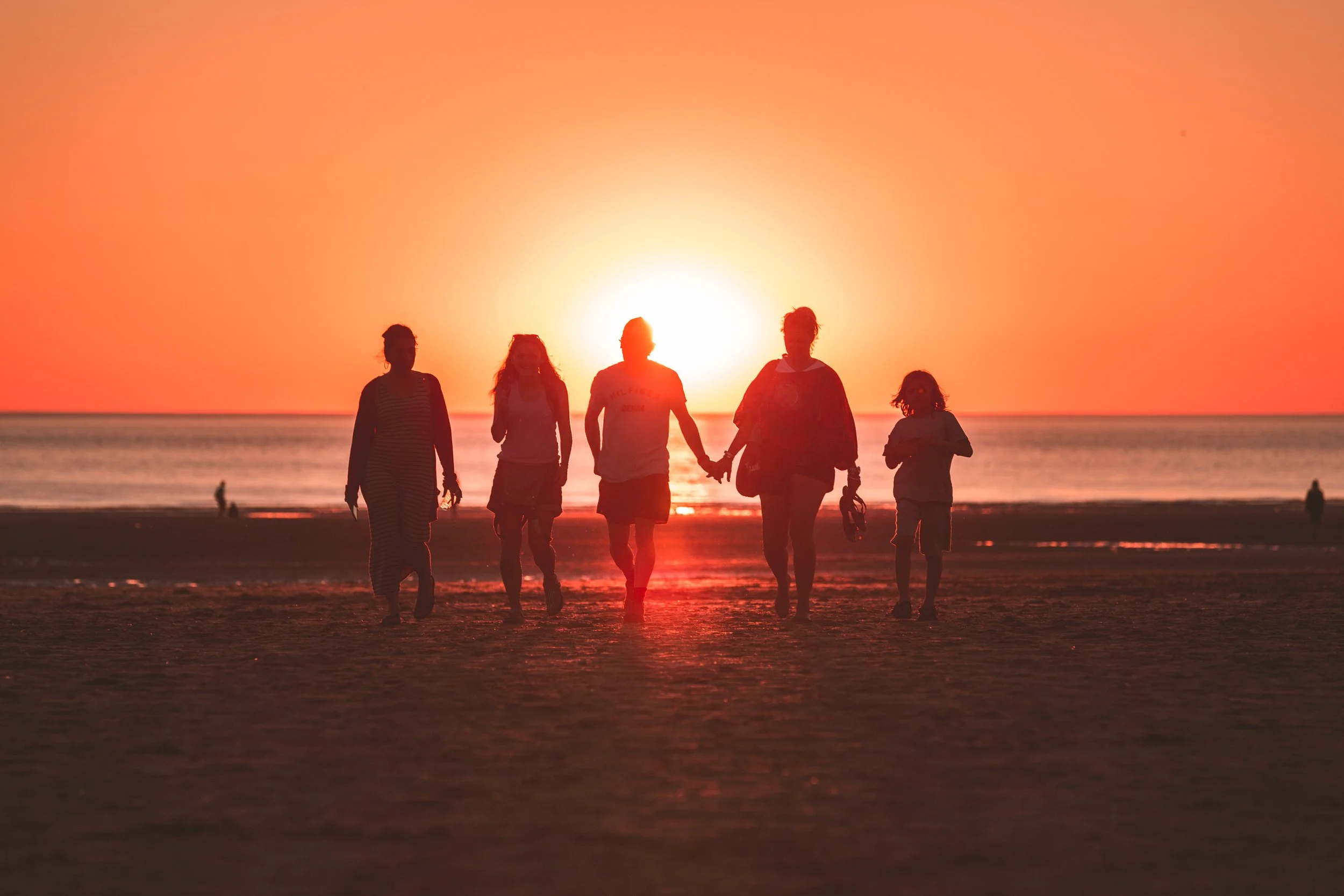  A family walking into an orange sunset. Showing that community can help with depression treatment in Broomfield, CO. With support of a depression therapist you can overcome the change in daylight with therapy in Broomfield or Denver, Colorado. 